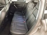 the back seat of a car with a remote control in the back of it