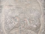 a silver plate with a picture of a man and a woman on it
