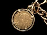 an image of a gold chain with a coin attached to it