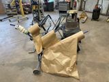 a cart with a roll of paper on it in a garage