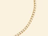 a yellow gold tennis bracelet with diamonds on a white background