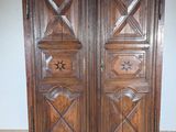 a wooden armoire with a star design on it