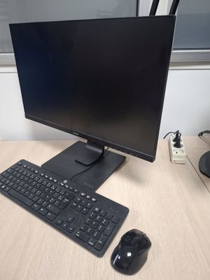 a computer monitor, keyboard, mouse and mouse on a desk