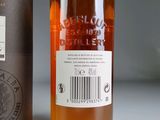 an image of a bottle of whisky next to a canister