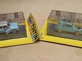 two toy cars that are in a box on a table