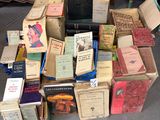 many books stacked on top of each other on the floor