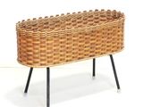 a wicker basket that is sitting on a stand