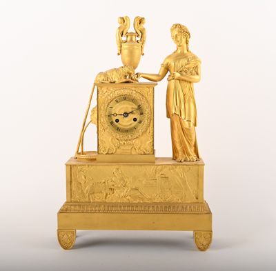 an image of a gold clock with a woman holding a vase