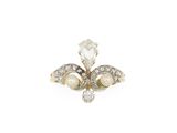 a close up of a diamond and pearl ring on a white background