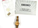 a watch that is sitting on a table next to a bag