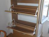 a room with a wooden book shelf and a chair in it