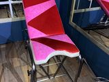 two chairs that are sitting in front of a mirror
