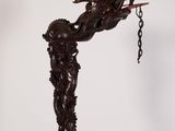 statue of a man holding a sword with a chain hanging from it ' s end