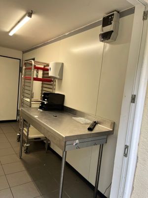 une photo d'une cuisine avec une table et une cuisinière