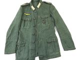an army green jacket with a small patch on the chest
