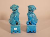 pair of blue foo foo foo statues sitting on top of a blue box