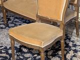 two chairs and a chair on a rug in a room
