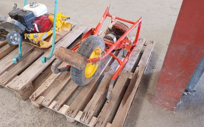 a small engine sitting on a pallet next to a fire hydrant
