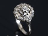 a close up of a diamond ring on a black surface