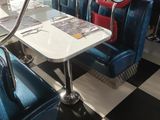 tables and chairs in a diner with a checkered floor