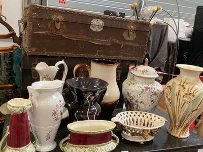 many different vases and bowls on a table
