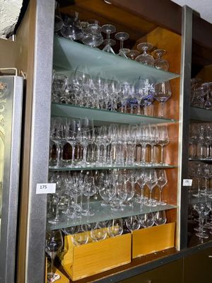 many glasses on the shelves in the room