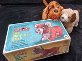 two stuffed animals that are sitting next to a box