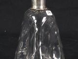 a clear glass bottle with a black lid