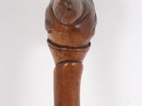 an old wooden walking stick with a wooden handle on a white background