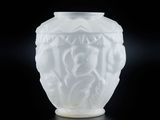 a white vase with a design on it on a black surface