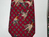 two ties with birds on them hanging on a wall