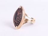 a close up of a ring with a leaf design on it