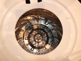 a close up of a white toilet with a metal lid