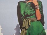a woman in a green dress posing for a picture