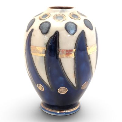 a blue and white vase on a white surface