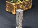 a close up of a metal object on a table next to a box