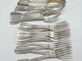several spoons and forks are arranged in a row on a white surface