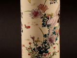 a vase with a design of flowers and birds on it