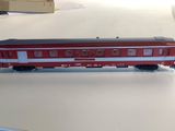 a toy train sitting on a table with a box in the background