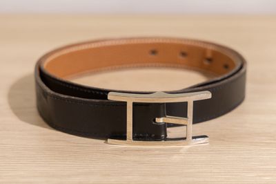 a close up of a black leather belt with a silver buckle