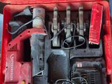 a red tool box with tools in it on a table