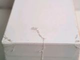 a close up of a piece of white paint on a piece of wood