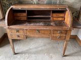 a wooden desk with a marble top in a room