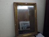 a mirror that is sitting on a table next to a window