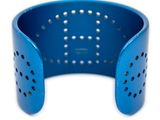 a close up of a blue bracelet on a white background