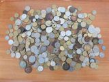 a pile of coins sitting on a wooden table