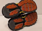 the soles of a pair of hiking shoes on a white surface