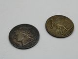 two coins that are sitting next to each other on a table