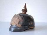 a helmet with a decorative decoration on it on a white surface