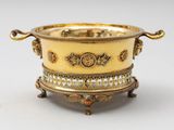 an image of a gold plated bowl with handles on a stand